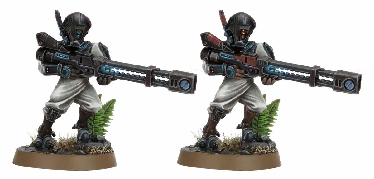 Two identical painted miniature sci-fi soldiers, each holding a large futuristic rifle, stand side-by-side on separate bases…