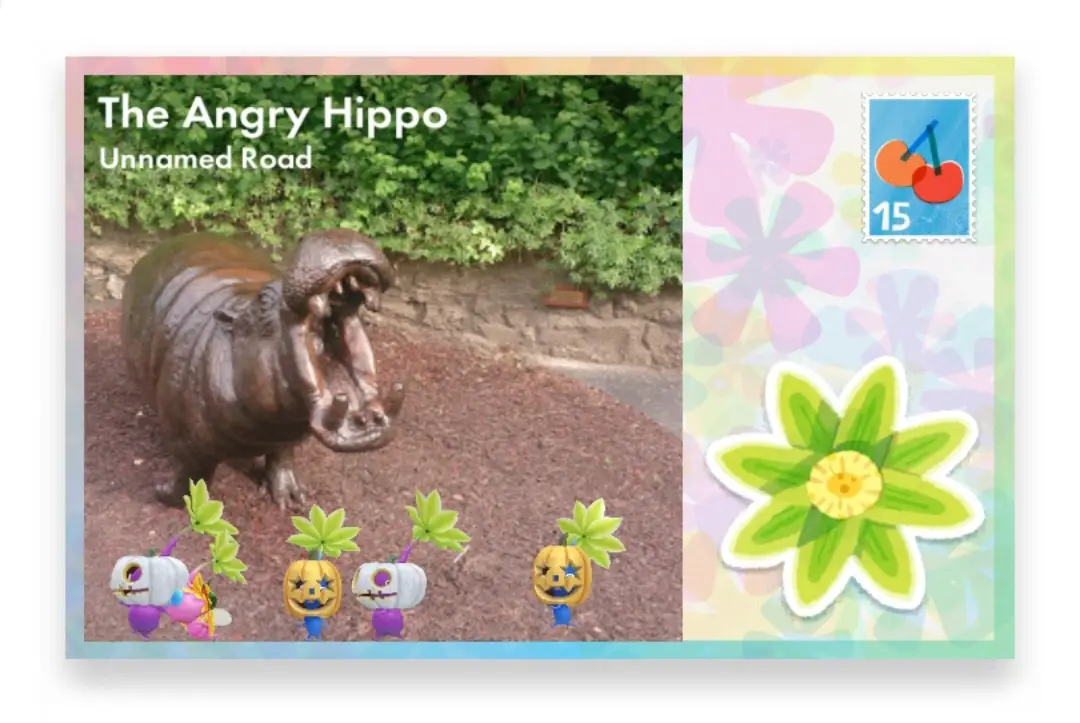 A postcard-style image shows a bronze hippo statue with its mouth open, labeled 'The Angry Hippo' and 'Unnamed Road'. In…