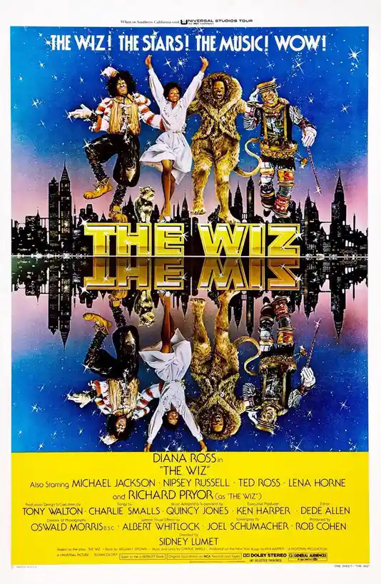 This image is a movie poster for 'The Wiz' featuring four main characters floating above a city skyline against a starry…