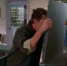 A man in a dark jacket is shown in six sequential frames struggling to push a heavy, dark-colored door. He starts with…