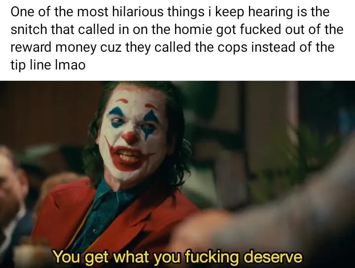 The image shows a close-up of the Joker from the movie 'Joker' (2019), wearing his iconic red suit and white face paint with…