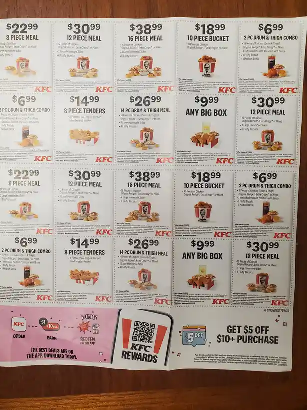 A printed KFC menu featuring multiple meal deals with prices like $6.99, $9.99, $14.99, $22.99, $26.99, $30.99, and $38.99…