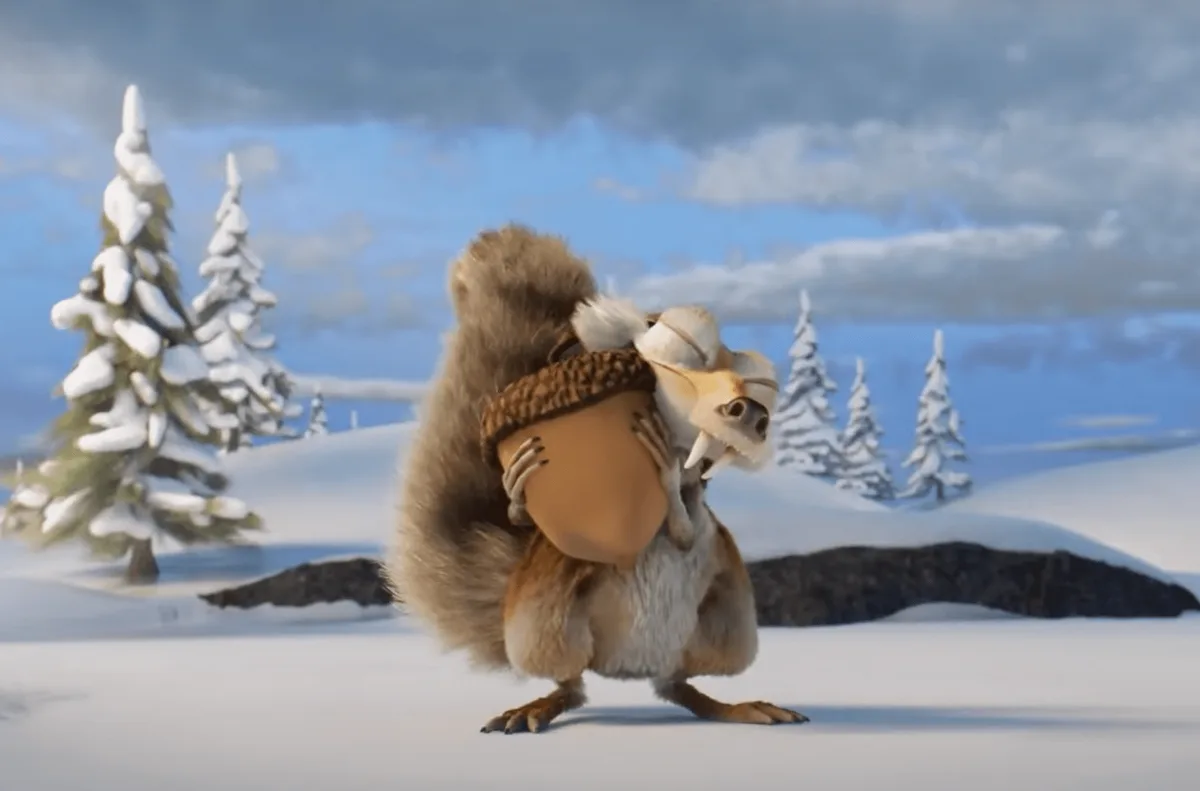 A cartoon squirrel stands in a snowy landscape holding a large acorn, with a smaller squirrel character clinging to its…