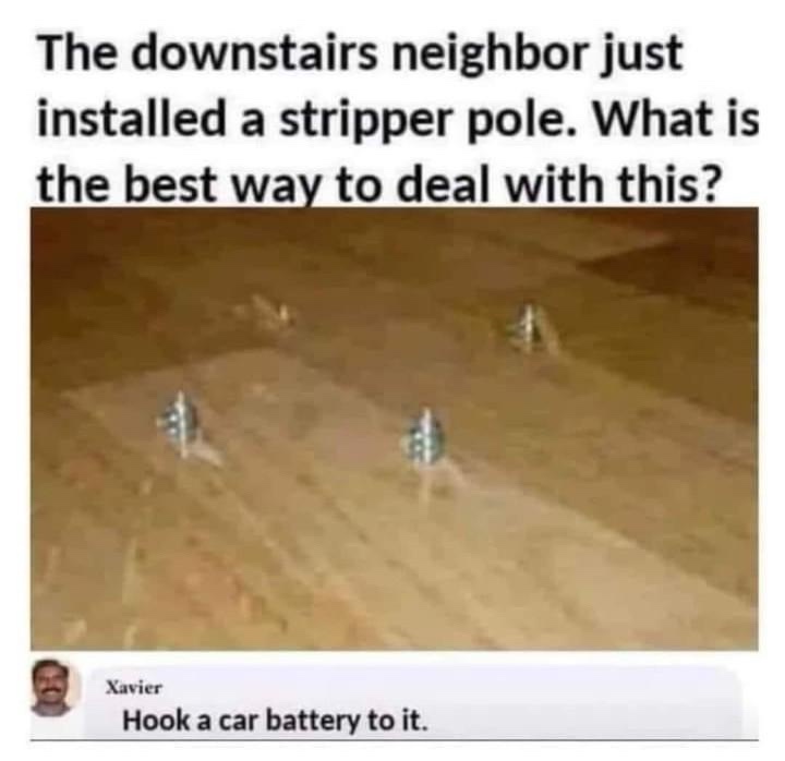 The image shows a blurry, low-resolution photo of four small, metallic, cylindrical objects arranged in a row on a wooden…
