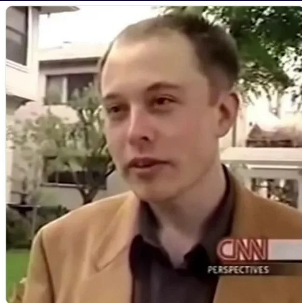 a still image of a young elon musk from a cnn perspectives interview, looking slightly off-camera with a neutral expression…