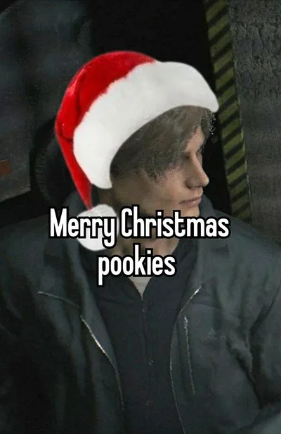 A person with short brown hair wearing a red and white Santa hat and a dark jacket, looking sideways with a neutral…