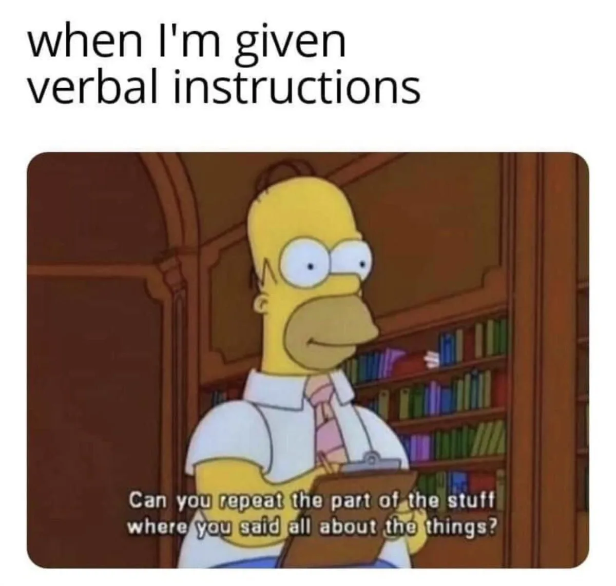 The image shows Homer Simpson in a library setting, holding a clipboard and looking slightly confused or uncertain. He is…