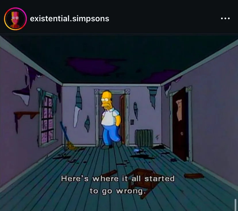 Homer Simpson stands in a dilapidated, ruined room with peeling walls, a broken ceiling, and scattered debris. The overlaid…
