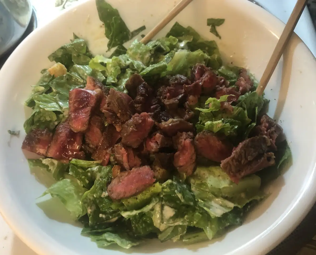 Indulging in Steak and Caesar Salad Delight