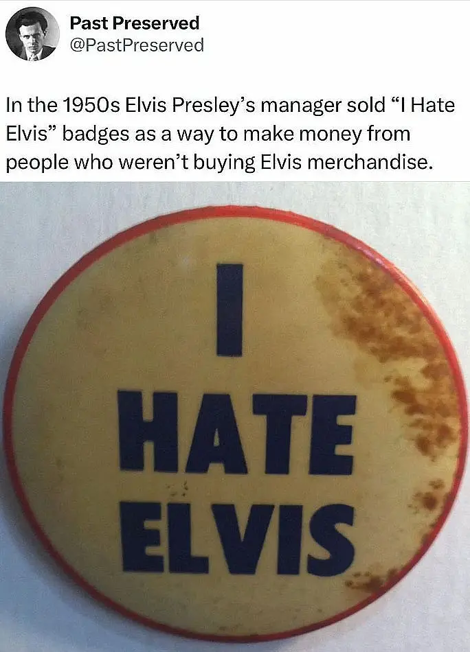 A close-up photo of a vintage, slightly stained circular pin with a red border and yellowish background, featuring the bold…