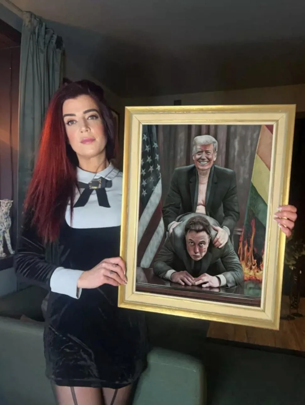 A woman with red hair and a black-and-white dress holds a framed painting depicting Donald Trump standing behind Elon Musk…
