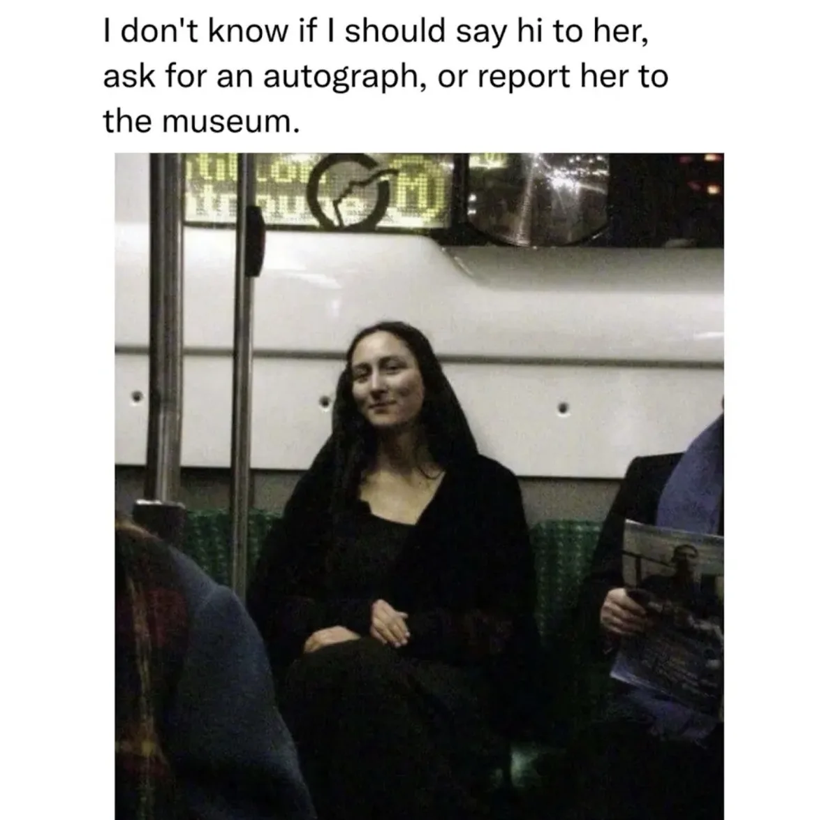 A woman with long dark hair and a faint smile sits on a subway train, dressed in black, looking like the Mona Lisa. The…