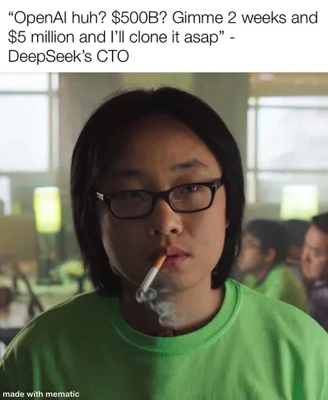 A person with dark hair, glasses, and a green t-shirt smokes a cigarette while looking directly at the camera. The overlaid…