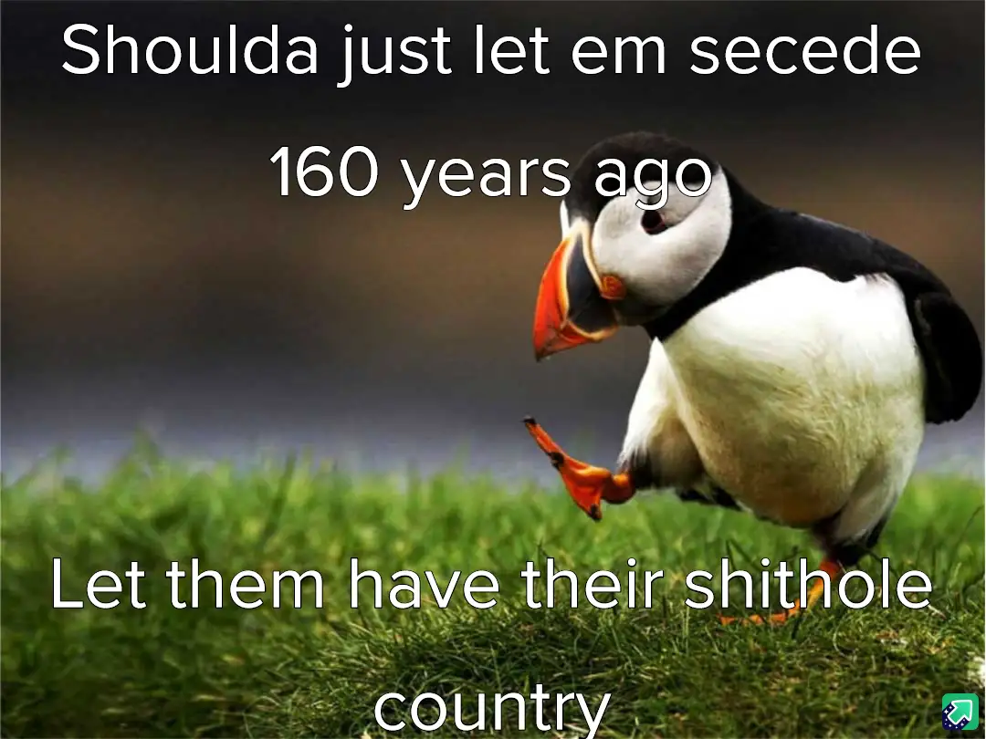 A photograph of a puffin standing on green grass with a blurred background, looking sideways with one foot lifted. White…
