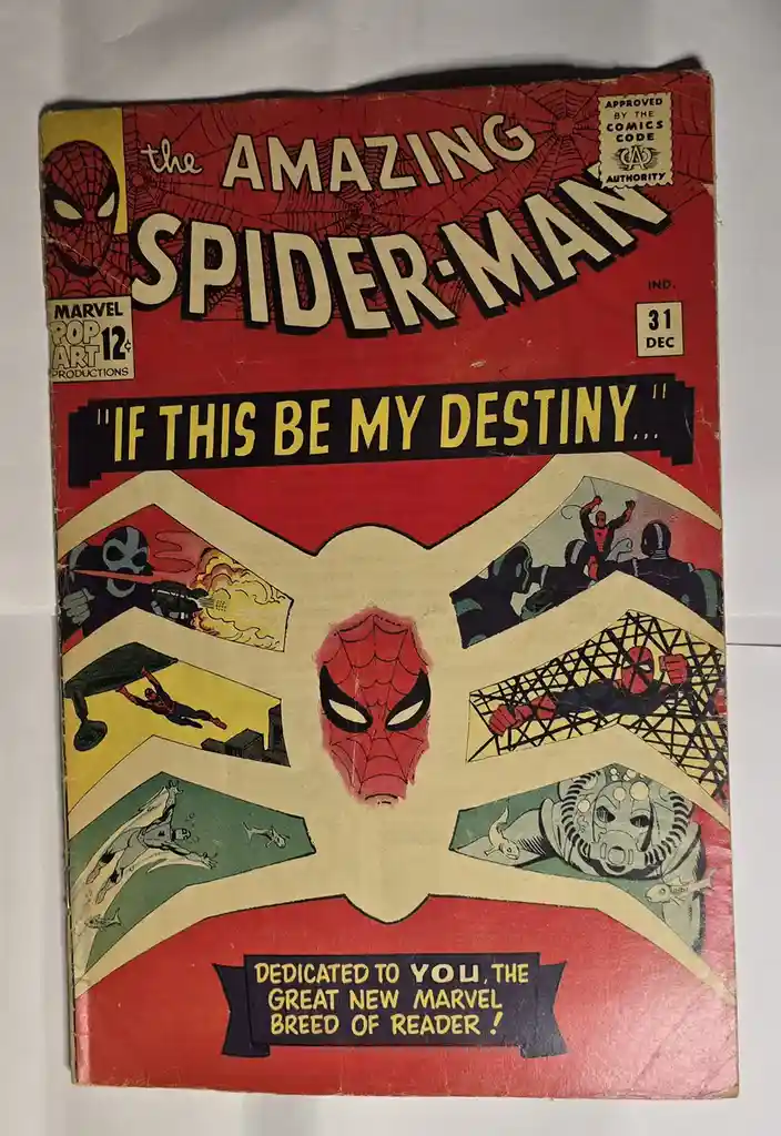 The cover of 'The Amazing Spider-Man' comic issue #31 from December, featuring a central Spider-Man mask surrounded by four…