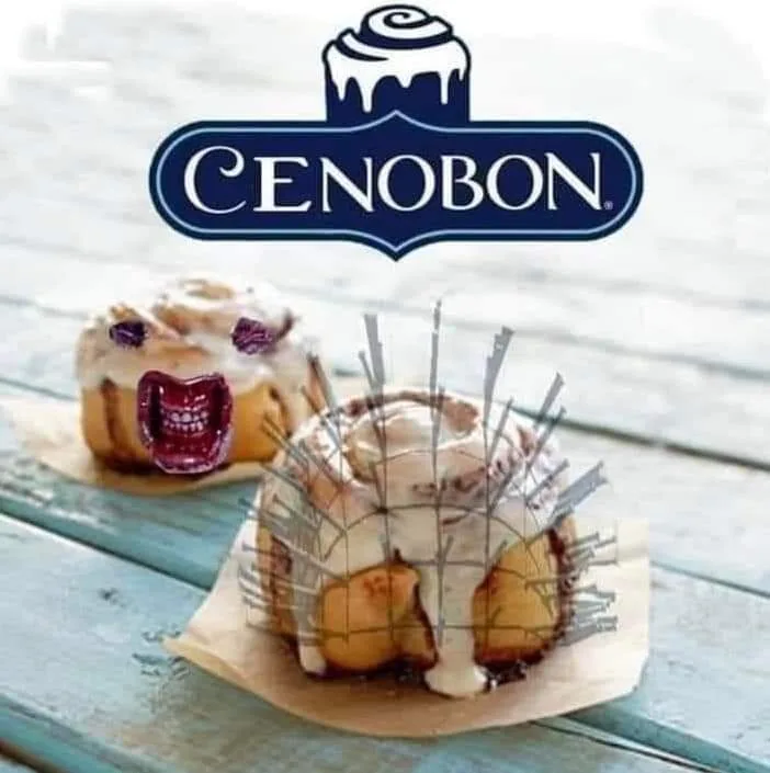 Two cinnamon rolls sit on a wooden table, one with a cartoonish screaming mouth and the other with a spiked, menacing…