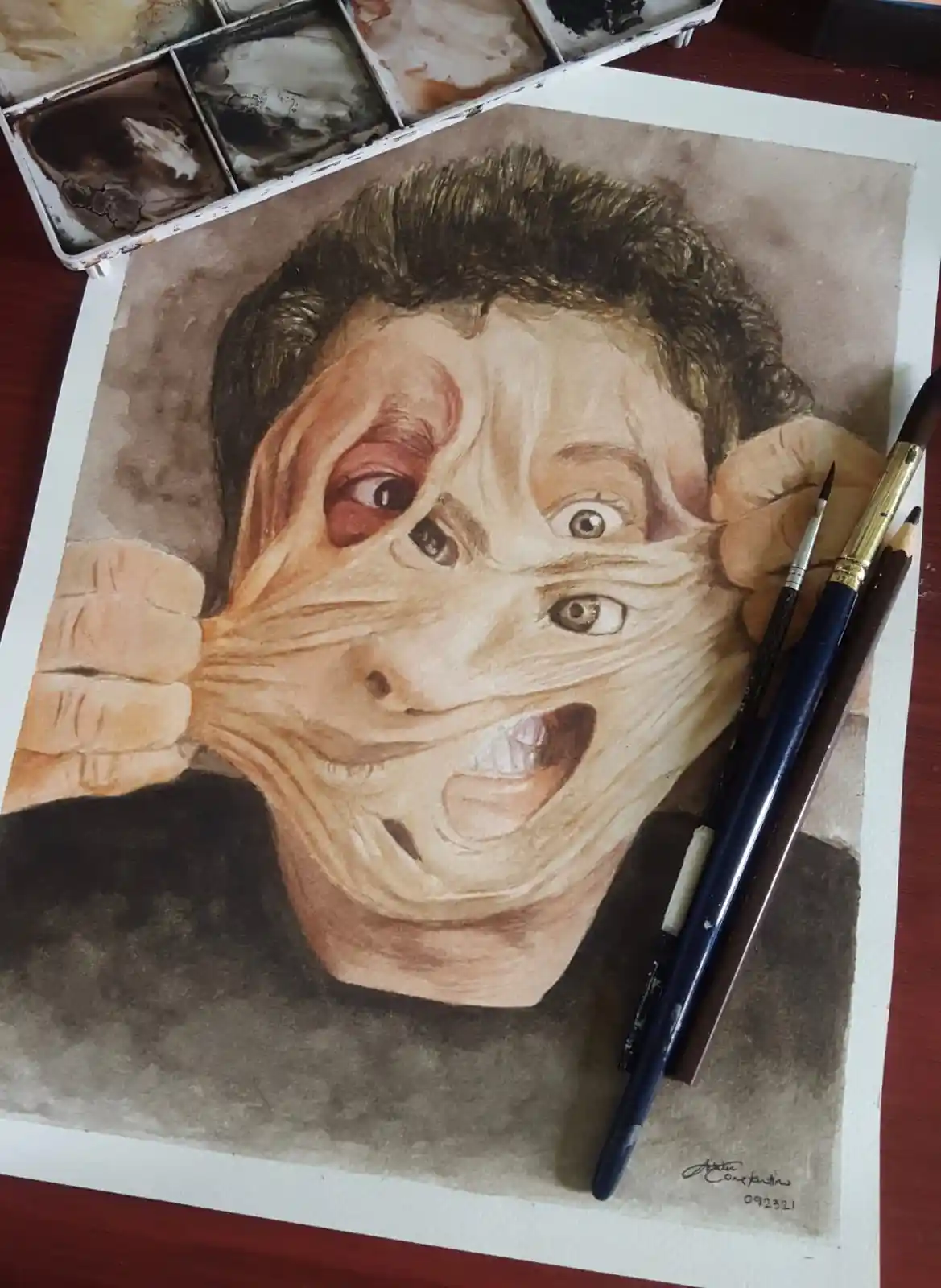 A watercolor painting depicts a person's face being stretched and distorted by hands pulling at the skin, creating a…