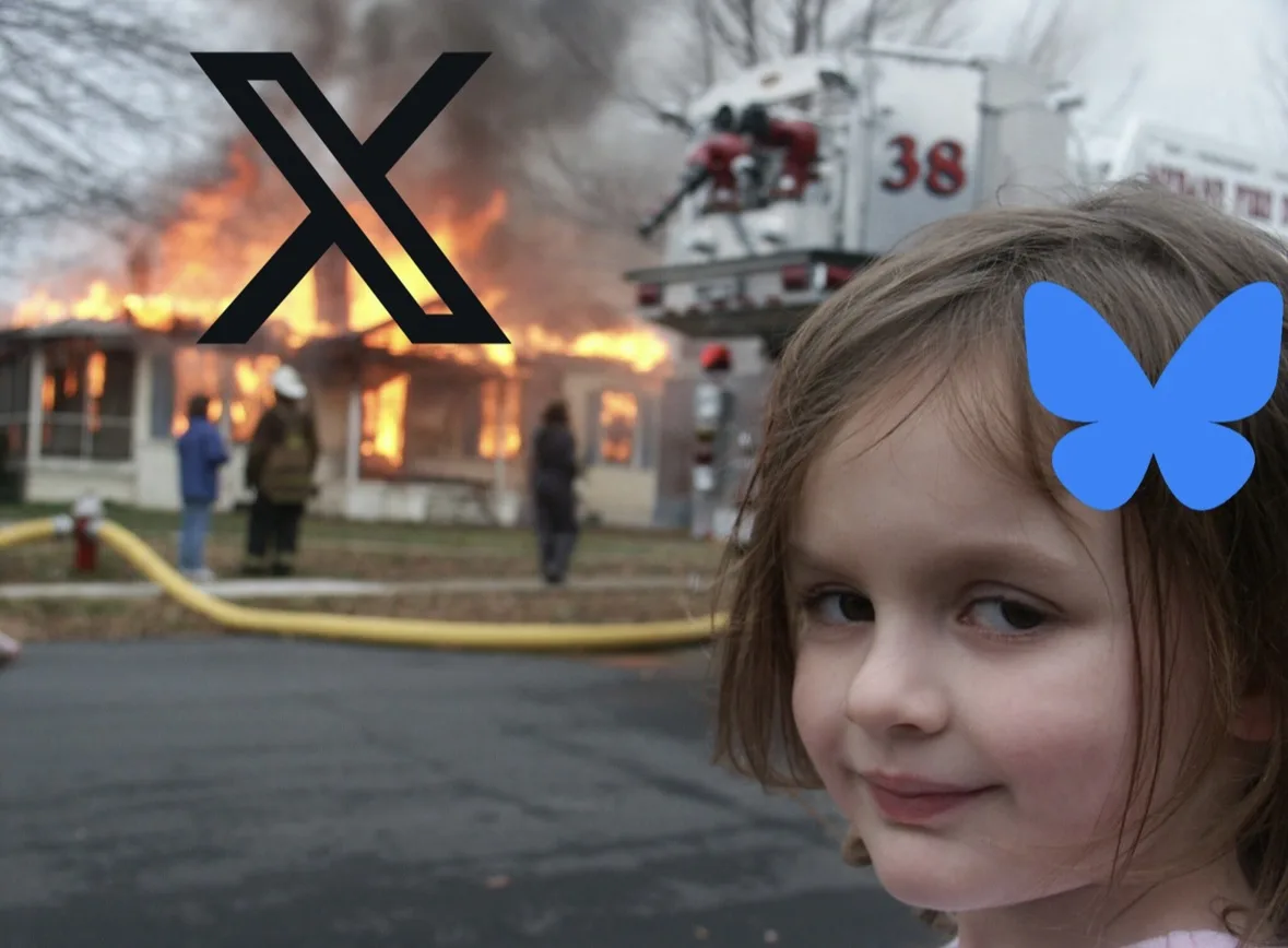 A young girl with a blue butterfly sticker on her forehead smiles calmly while a house burns in the background with…