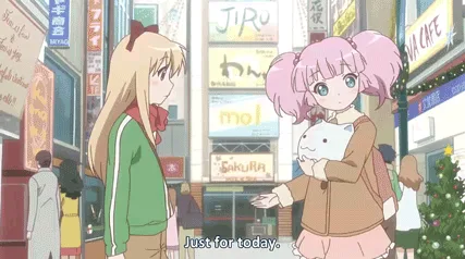 A split-screen anime scene shows two girls in a city street; one with pink pigtails holds a white cat plushie while the…