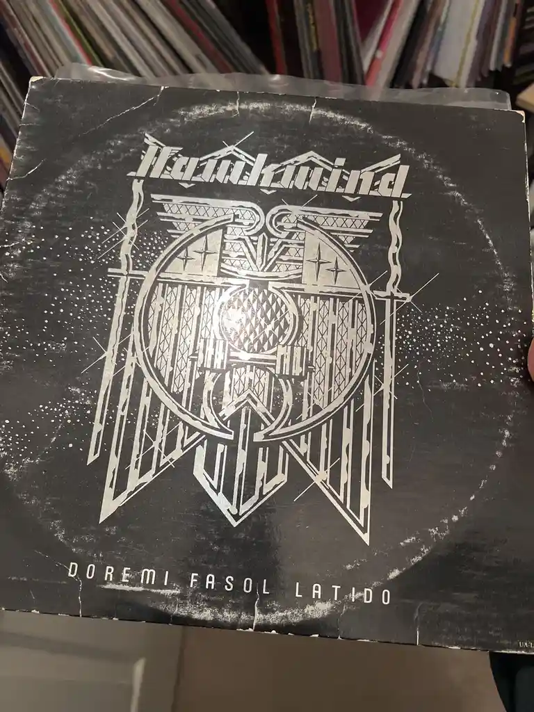 A close-up of a worn, black-and-white album cover for the band 'Hawkwind', featuring their logo and the title 'Doremi Fasol…