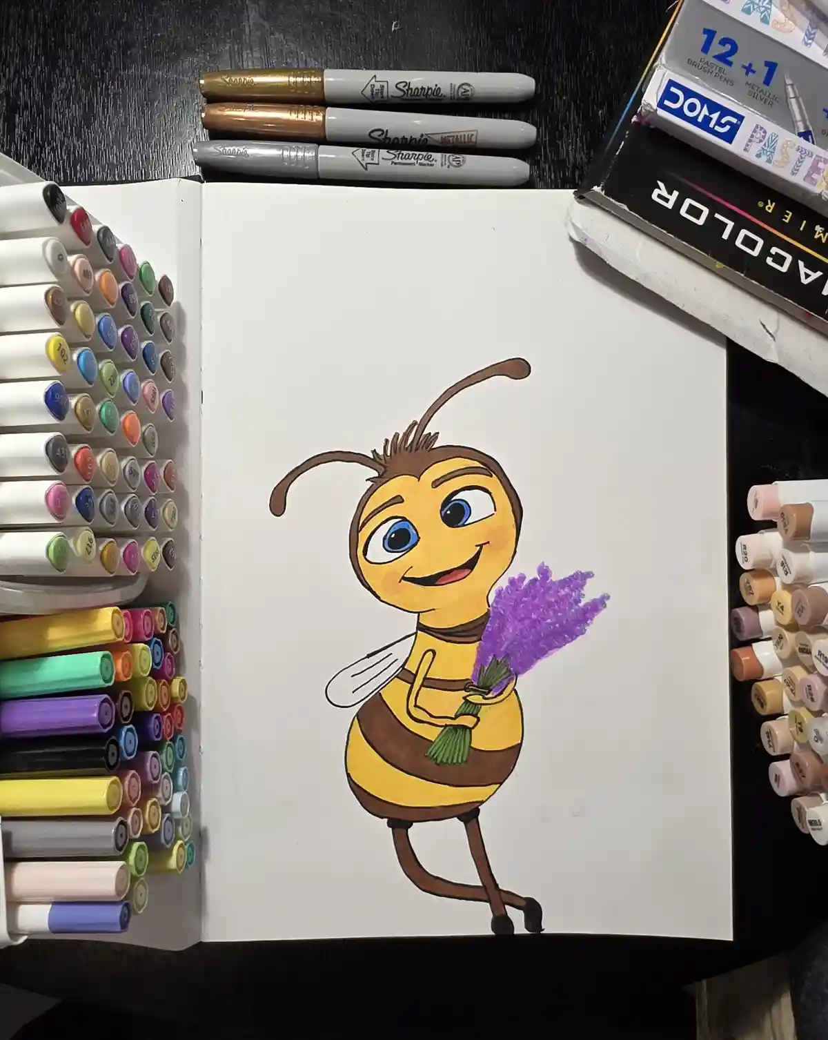 A hand-drawn cartoon bee with large blue eyes and a cheerful smile holds a purple bouquet of flowers. The drawing is on a…