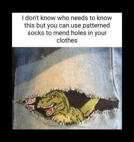 A close-up photo shows a torn hole in blue denim jeans, patched with a green pixelated dinosaur pattern, resembling a sock…
