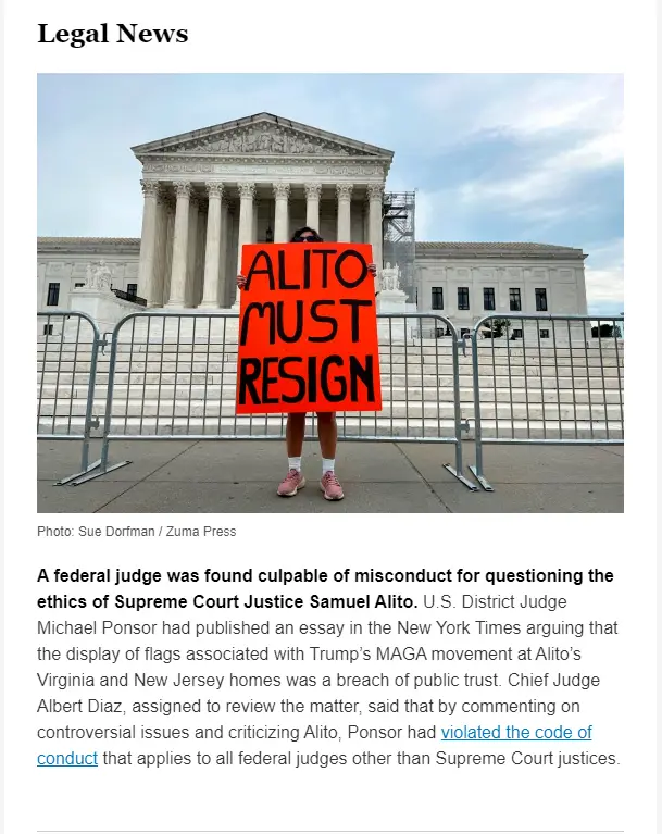 A person stands in front of the U.S. Supreme Court building holding a bright orange sign with bold black text reading 'ALITO…