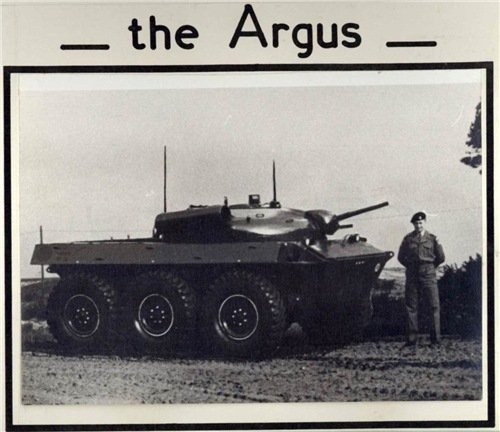 A black-and-white photo shows a man in military uniform standing next to a six-wheeled armored vehicle, with the text 'the…