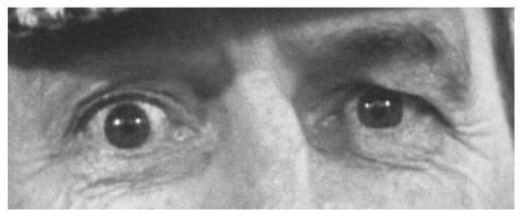 A black-and-white close-up of a man's eyes, showing wide, startled pupils and wrinkled skin around them. The overlaid text…