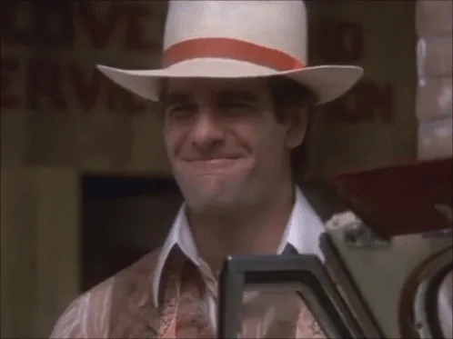 A six-panel image shows actor John Travolta in a white cowboy hat with an orange band, wearing a patterned shirt, standing…