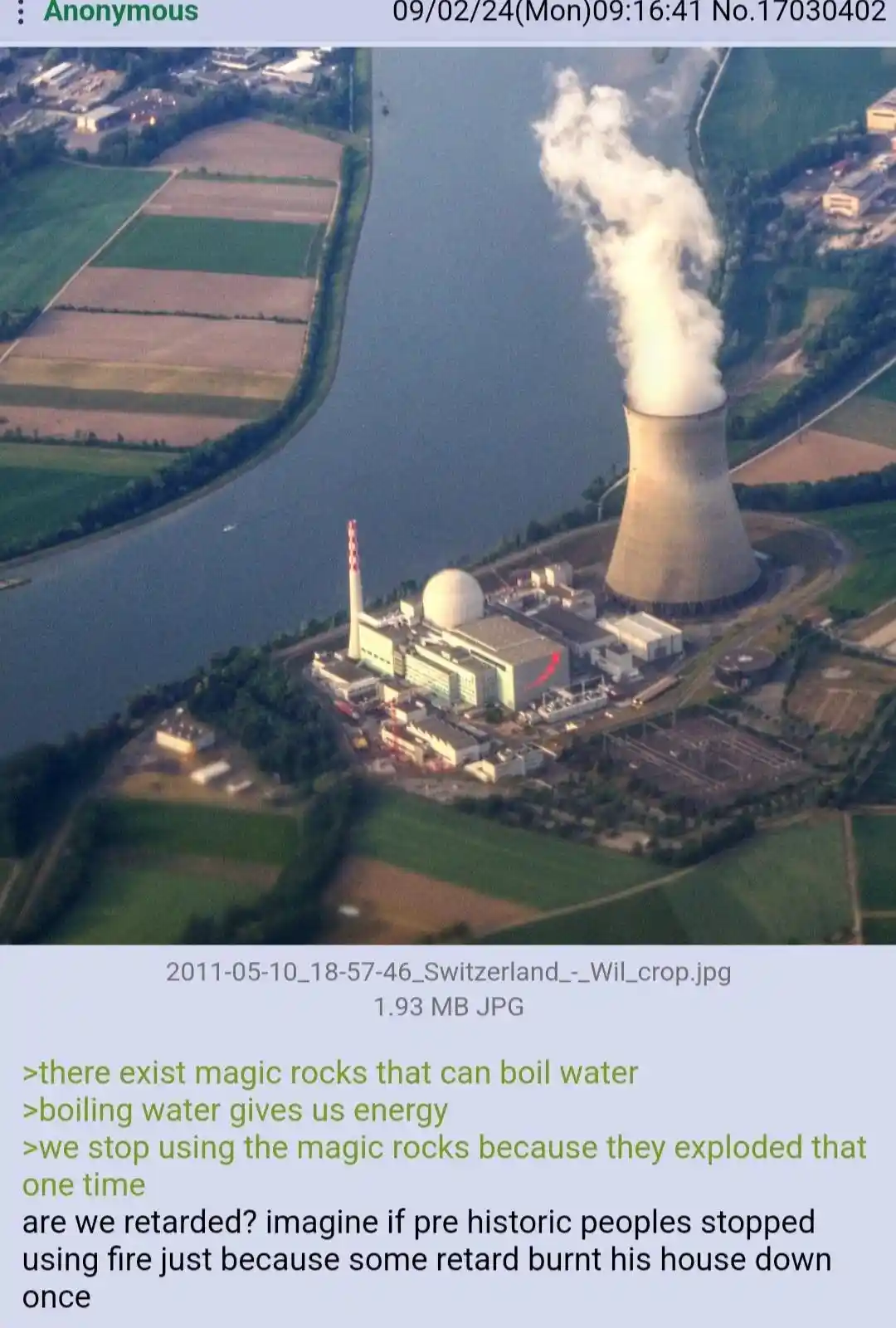 An aerial photo of a nuclear power plant with a cooling tower emitting steam, situated beside a river and surrounded by…