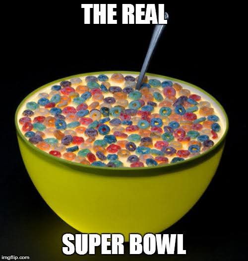 A bright yellow bowl filled with colorful, ring-shaped cereal pieces submerged in milk, with a metal spoon sticking out. The…