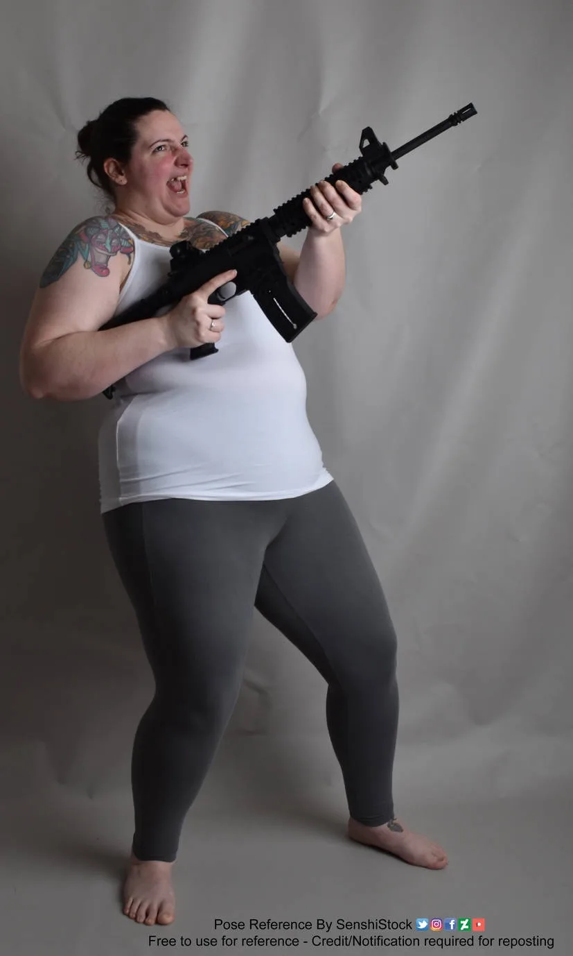 A woman with tattoos on her arms and shoulders, wearing a white tank top and grey leggings, is posing with a black rifle…
