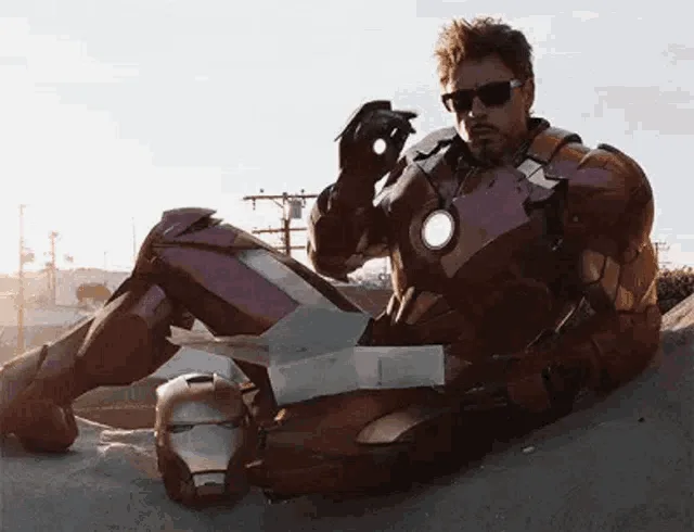 A six-panel image shows Tony Stark in his Iron Man suit, sitting on the ground with his helmet beside him, repeatedly…