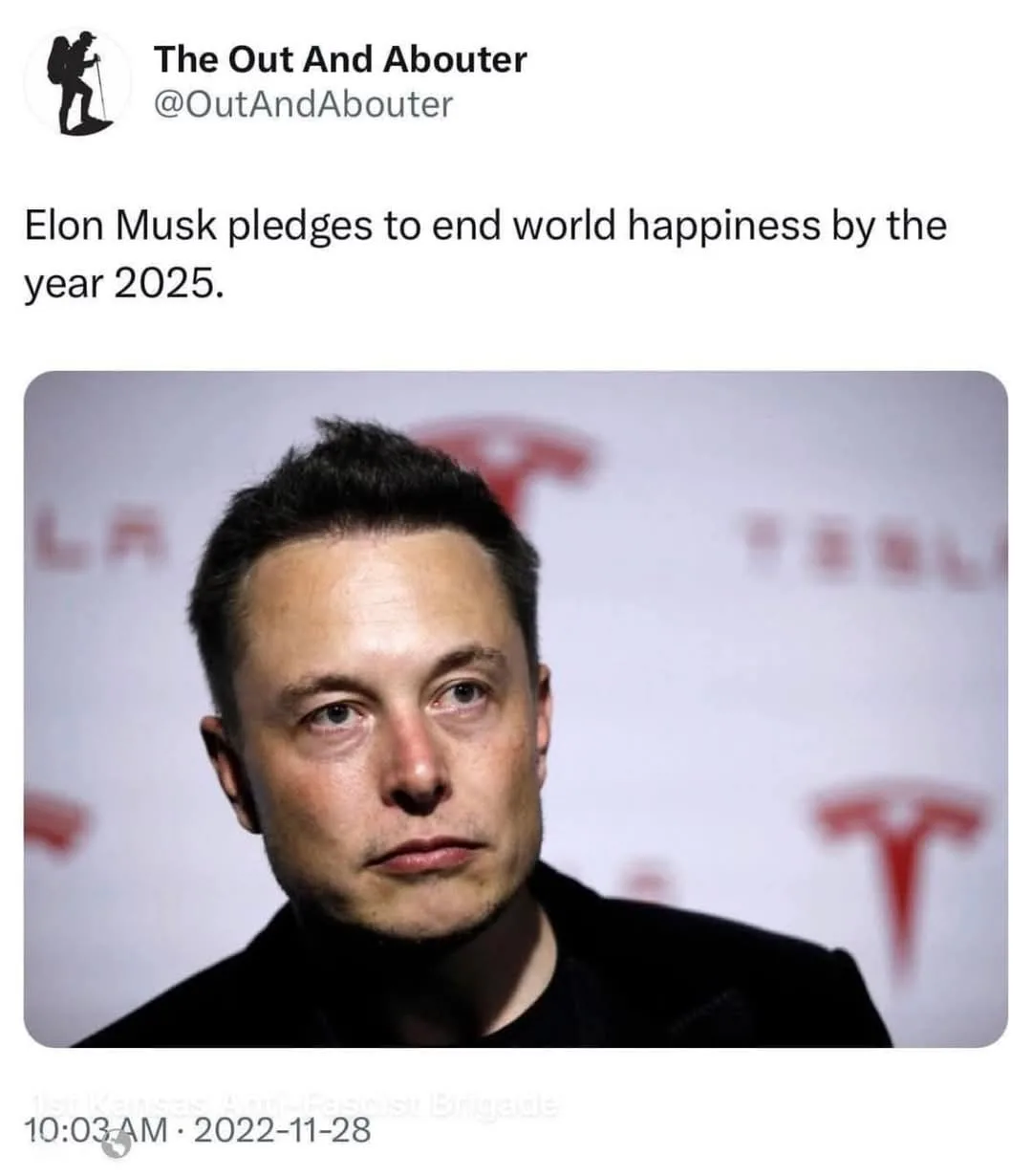 A close-up photo of Elon Musk looking serious and slightly tired, set against a white backdrop with blurred red Tesla logos…