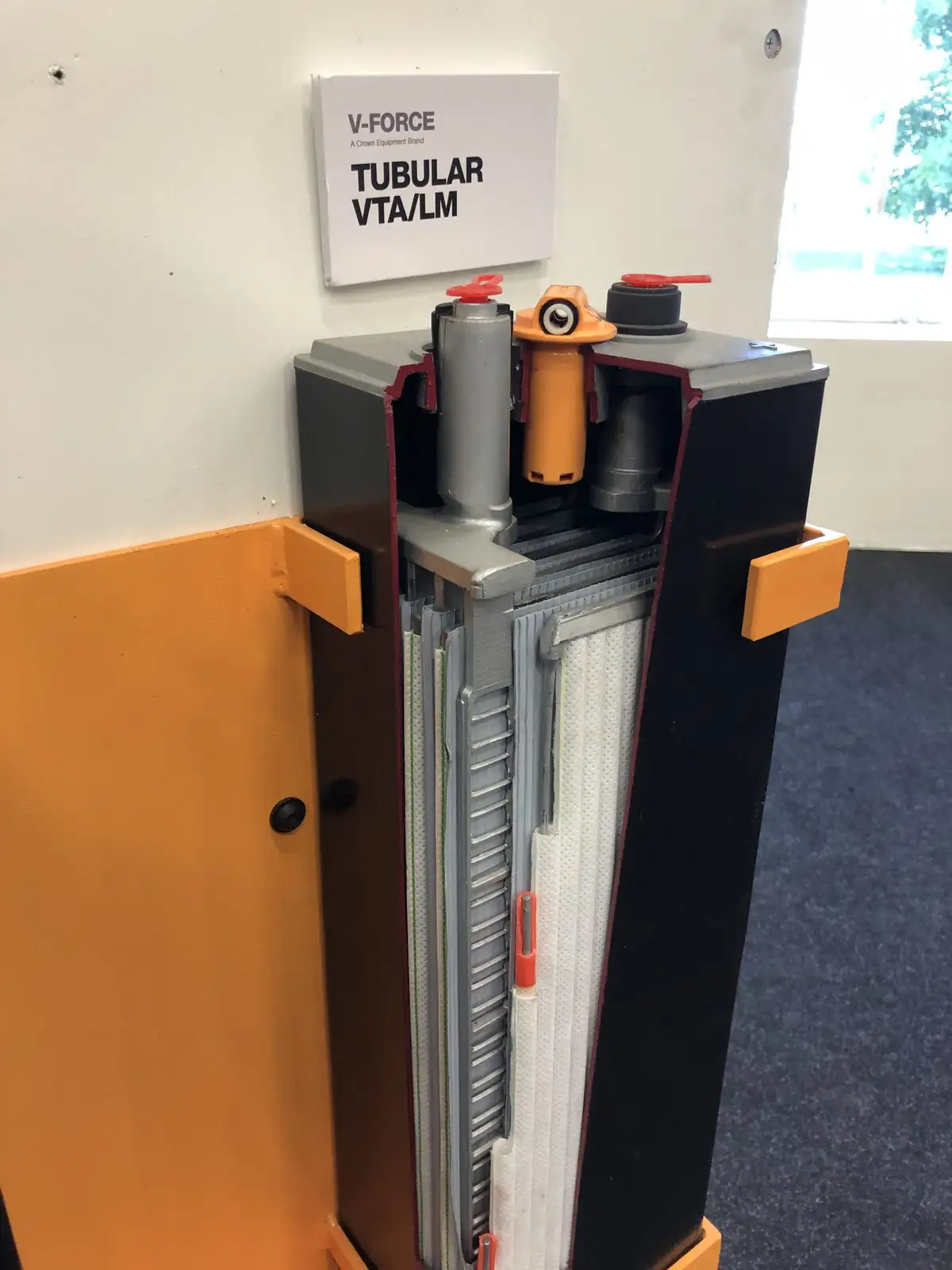 A cutaway model of a V-FORCE tubular VTA/LM industrial machine is displayed, revealing its internal components like filters…