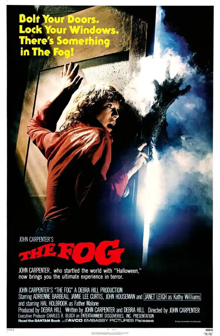 A vintage movie poster for John Carpenter's 1980 horror film 'The Fog' shows a terrified woman in a red shirt pressing her…