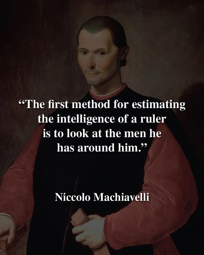 A classical portrait of Niccolo Machiavelli, a man with short dark hair and a slight smile, wearing a black doublet with red…