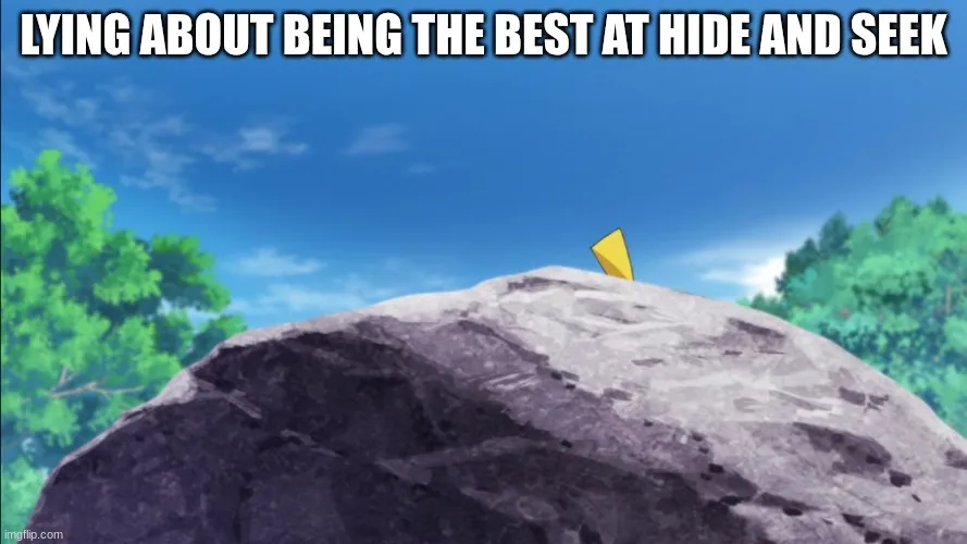 A cartoon image shows a large grey boulder under a blue sky with green trees on either side. Perched on the very top of the…