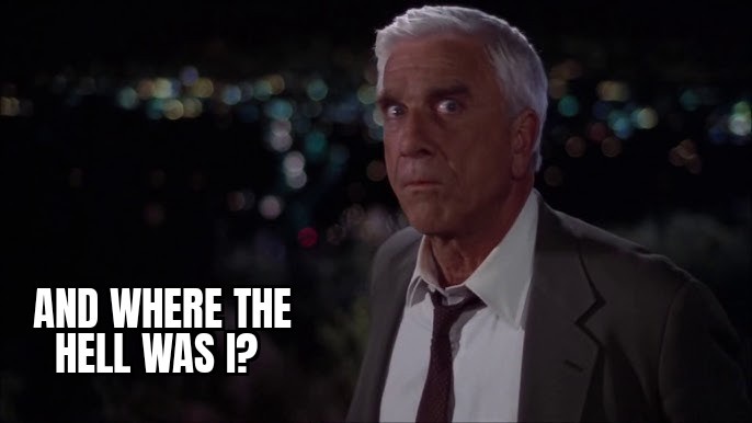 A man with white hair and a suit looks shocked and confused against a blurred nighttime city background. The text 'AND WHERE…