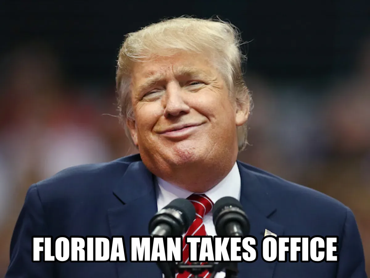 A close-up photo of Donald Trump smiling smugly while standing at a podium with two microphones, wearing a dark suit and red…
