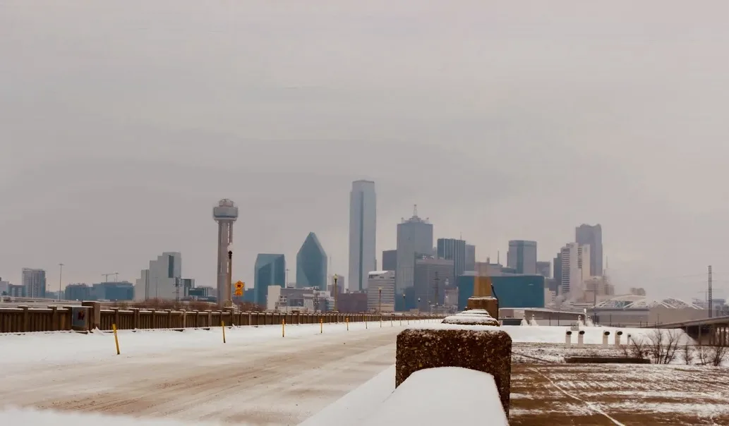 A snowy, empty road leads toward a hazy city skyline with recognizable skyscrapers. Overlaid text reads 'i'm not lazy, i'm…