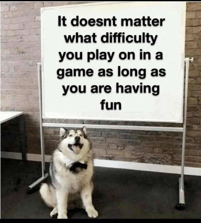 A happy-looking husky dog wearing a bowtie sits in front of a whiteboard that displays the text 'It doesnt matter what…