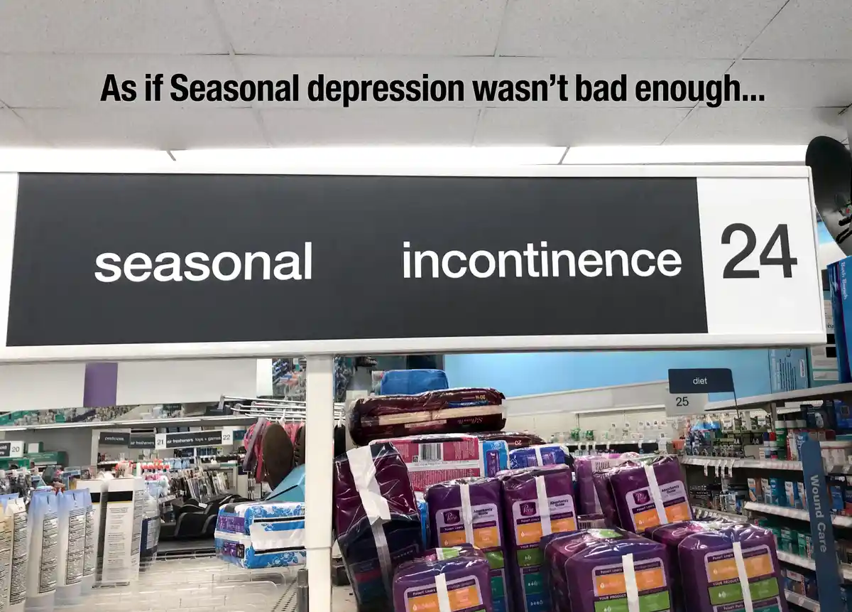 A photo of a store aisle with a black sign reading 'seasonal incontinence 24' above shelves of purple Poise incontinence…
