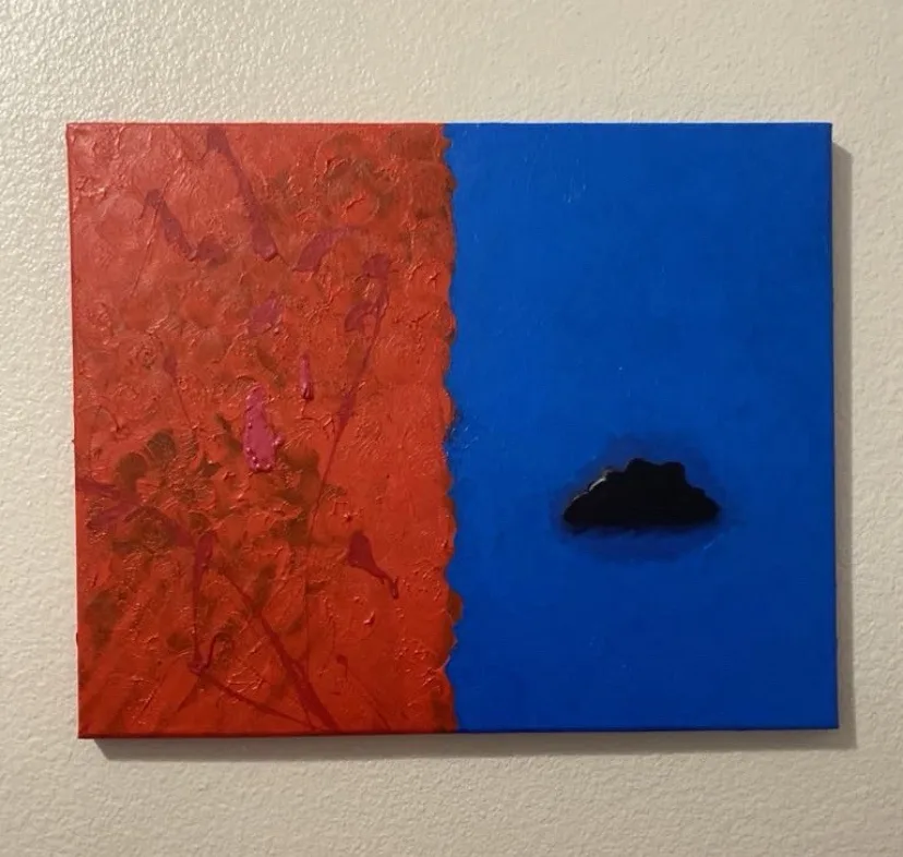 a canvas painting split vertically into a textured red left side and a smooth blue right side, with a small black cloud…