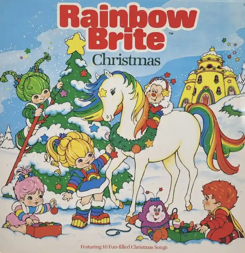 A colorful, vintage-style illustration for 'Rainbow Brite Christmas' shows several cartoon children and a unicorn with…