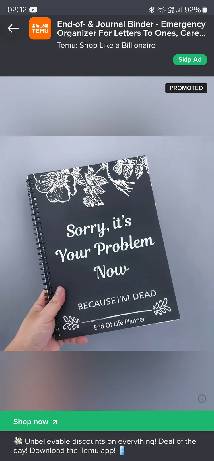 A hand holds a black spiral-bound notebook with white floral designs and the text 'Sorry, it's Your Problem Now BECAUSE I'M…