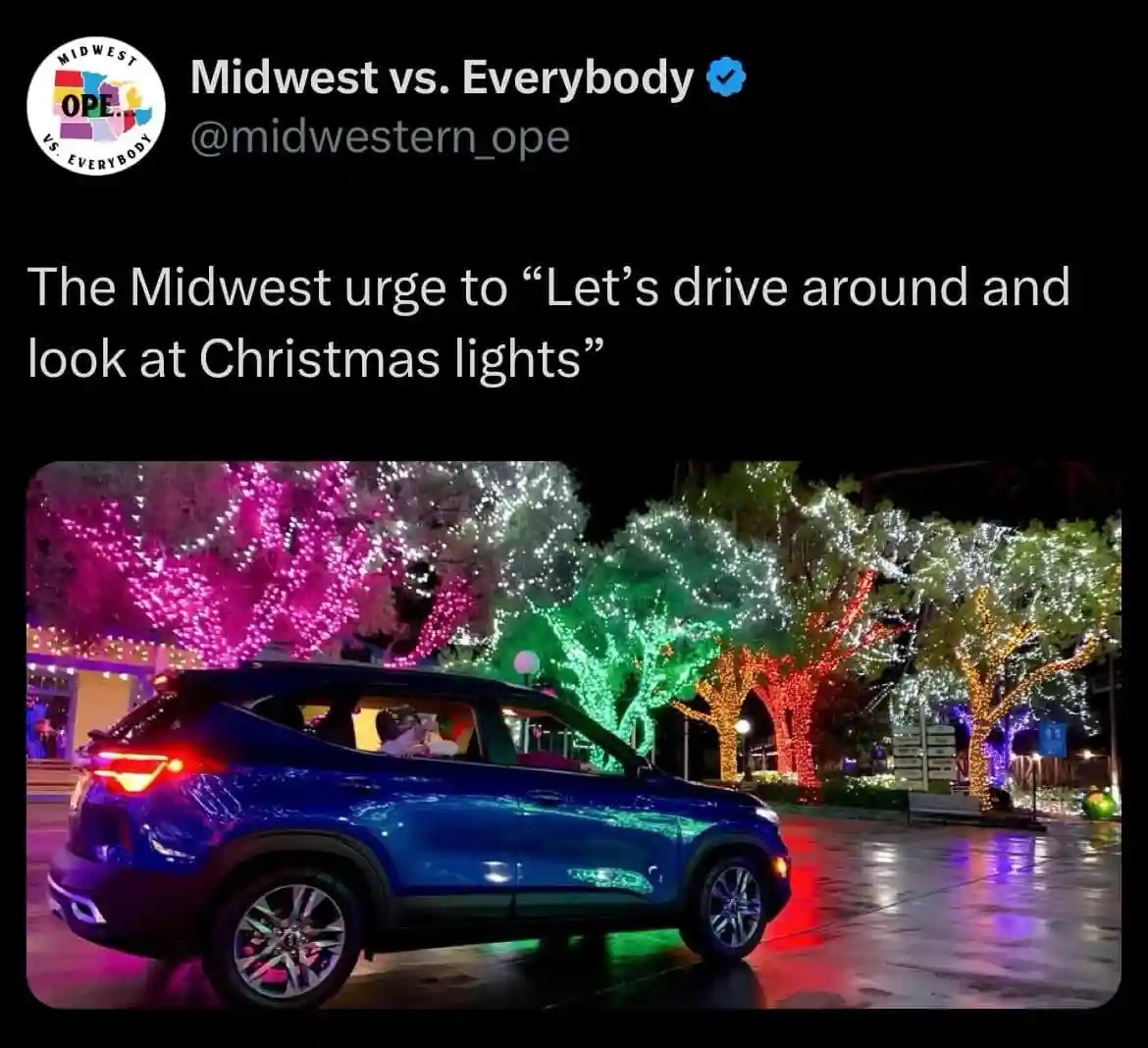 A blue SUV drives past trees adorned with colorful Christmas lights at night, with the overlaid text reading 'The Midwest…