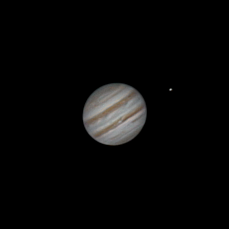 A space image shows the planet Jupiter with its characteristic swirling bands and a small, distant moon visible to its…