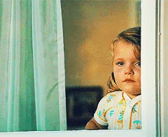 A grid of six identical photos shows a young child with light brown hair and wide eyes looking out from behind a window with…
